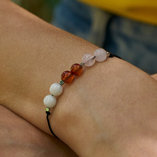 pulsera ajustable hecha a mano decorada con piedras naturales que promueven la fertilidad.